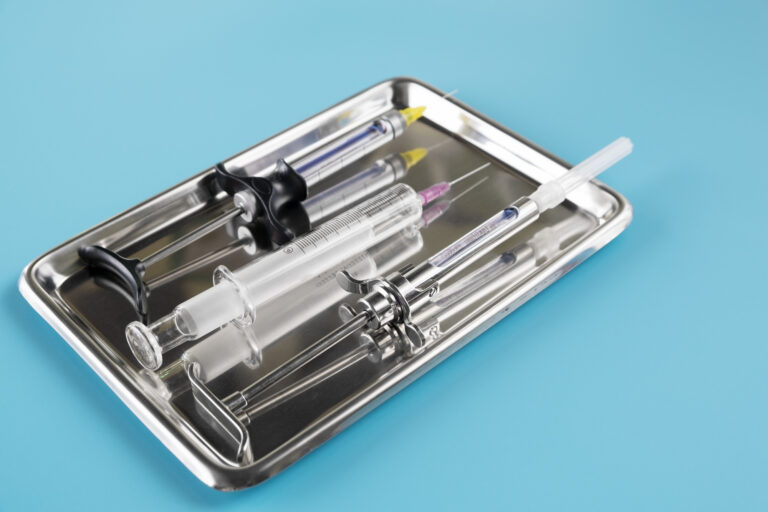stomatologia-narzedzia-medyczne-strzykawki-na-niebieskim-tle